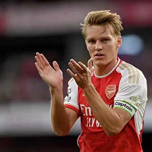 Arsenal's Martin Odegaard Applauding Fans Amidst the Drama: Arsenal FC vs Manchester City, 2023-24 Premier League