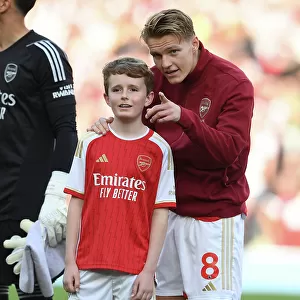 Arsenal's Martin Odegaard and the Mascot: United Before the Arsenal vs. Manchester City (2023-24) Match