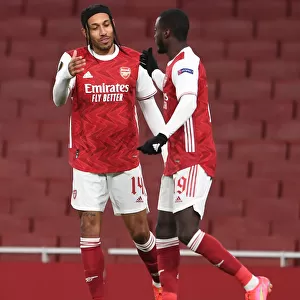 Arsenal's Nicolas Pepe and Pierre-Emerick Aubameyang Celebrate Goal in Empty Emirates Stadium during Arsenal v Slavia Prague UEFA Europa League Quarterfinal