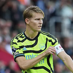 Arsenal's Odegaard Adjusts Captain's Armband in AFC Bournemouth Clash (2023-24)