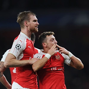 Arsenal's Ozil and Mertesacker Celebrate Goals Against Bayern Munich in 2015 Champions League Match