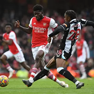 Arsenal's Partey Fends Off Willock in Intense Arsenal v Newcastle Clash