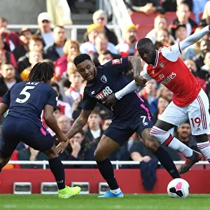 Arsenal's Pepe Clashes with Bournemouth's King and Ake during the 2019-20 Premier League Match