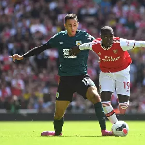 Arsenal's Pepe Clashes with Burnley's McNeil in Premier League Showdown