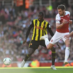 Arsenal's Ramsey Fends Off Doucoure and Cathcart Pressure During Arsenal v Watford Match