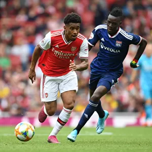 Arsenal's Reiss Nelson Outmaneuvers Olympique Lyonnais Bertrand Traore at Emirates Cup