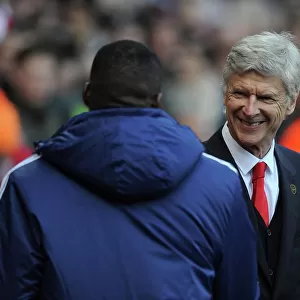 Arsene Wenger the Arsenal Manager with Guy Demel (West Ham) before the match. Arsenal 3