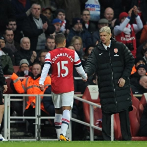 Arsene Wenger the Arsenal Manager shakes hands with Alex Oxlade-Chamberlain (Arsenal)