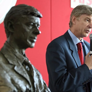Arsene Wenger the Arsenal Manager stands near his bust
