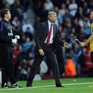 Arsene Wenger Conferring with Thomas Vermaelen during West Ham United vs Arsenal (2012-13)