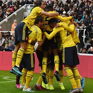 Aubameyang Strikes: Guendouzi and Mkhitaryan Celebrate Arsenal's Winning Goal vs. Newcastle United