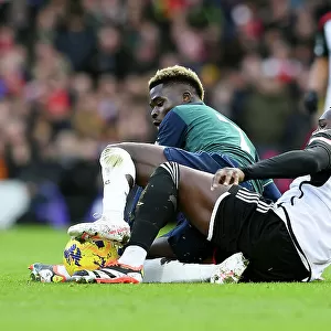 Battling for Possession: Saka vs. Bassey in the Fulham vs. Arsenal Premier League Clash (2023-24)