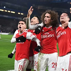 Celebrating Victory: Torreira, Guendouzi, and Xhaka Rejoice After Arsenal's Goal vs. Chelsea (Premier League 2019-20)