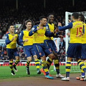 Celebrating Victory: Welbeck, Coquelin, and Oxlade-Chamberlain Rejoice After Arsenal's Goals vs. West Ham United (2014-15)