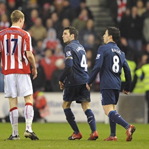 Cesc Fabregas and Samir Nasri (Arsenal) clash with Ryan Shawcross (Stoke)