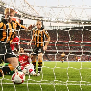 Cesc Fabregas scores Arsenals goal under pressure from Paul McShane