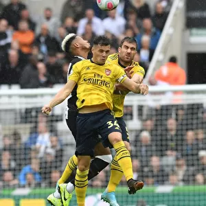 Clash at St. James Park: Xhaka and Sokratis Battle for Control in Newcastle United vs. Arsenal FC, Premier League 2019-20