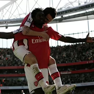 Emmanuel Adebayor celebrates scoring his and Arsenal s