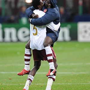 Emmanuel Adebayor and Emmanuel Eboue celebrate Arsenals victory