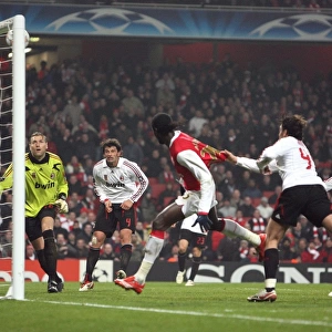 Emmanuel Adebayors header hits the crossbar as AC Milan goalkeeper Zeljko Kalac looks on