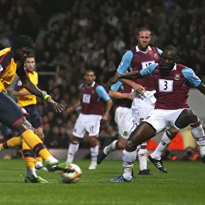 Emmanuel Adebayors shot hits West Hams Julien Flaubert