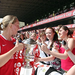 Faye White (Arsenal) shows of the troph to the fans