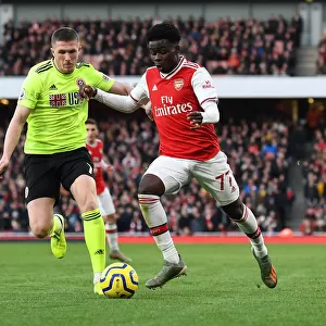 Intense Battle: Bukayo Saka vs. John Lundstram - Arsenal's Clash Against Sheffield United