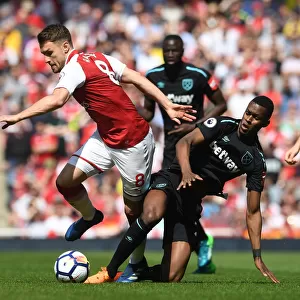 Intense Rivalry: Ramsey vs. Fernandes Clash in Arsenal vs. West Ham Football Match
