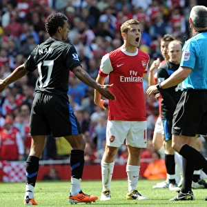 Jack Wilshere (Arsenal) and Nani (Man Utd) talk to Referee Chris Foy. Arsenal 1