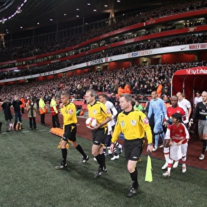The match officials lead the team out onto the picth before the match. Arsenal 4