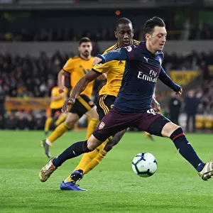 Mesut Ozil Under Pressure: Willy Boly Closes In during Wolverhampton Wanderers vs. Arsenal FC, Premier League 2018-19