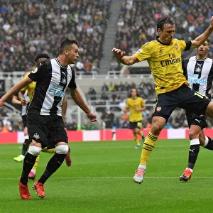 Nacho Monreal Faces Pressure from Javier Manquillo in Newcastle United vs Arsenal FC Premier League Clash