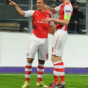 Podolski and Mertesacker Celebrate Arsenal's Second Goal Against Anderlecht in 2014-15 Champions League