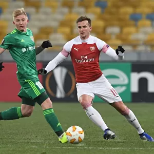 Rob Holding vs Vladyslav Kulach: Battle for Ball Possession in Arsenal's Europa League Clash with Vorskla Poltava