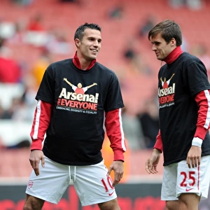Robin van Persie and Carl Jenkinson (Arsenal) warm up in thier Arsenal for Everyone T Shirt