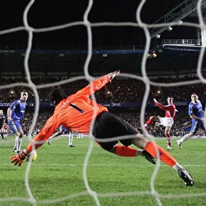 Robin van Persie shoots past Chelsea goalkeeper Petr