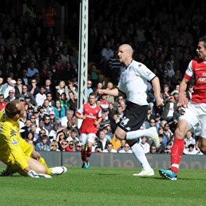 Robin van Persie shoots past Fulham goalkeeper Mark Schwarzer to score the 1st Arsenal goal
