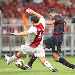 Robin van Persie shoots past Thomas Vermaelen to score the Arsenal goal