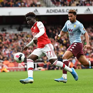 Saka vs. Trezeguet: A Premier League Showdown - Intense Face-Off Between Arsenal's Young Gun and Aston Villa's Midfielder