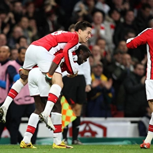 Samir Nasri, Emmanuel Eboue, and Carlos Vela: Celebrating Arsenal's First Goal in a 2-0 Win Against Standard Liege in the UEFA Champions League (2009)