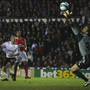 Theo Walcott shoots past Derby goalkeeper Roy Carroll to score the 4th Arsenal goal