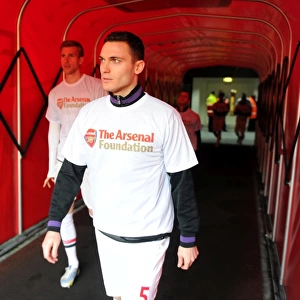 Thomas Vermaelen (Arsenal) walks out to warm up in his Arsenal Foundation t shirt