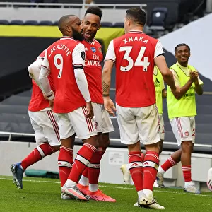 Triumphant Threesome: Lacazette, Aubameyang, and Xhaka's Victory Celebration (Arsenal vs. Tottenham, 2019-2020)