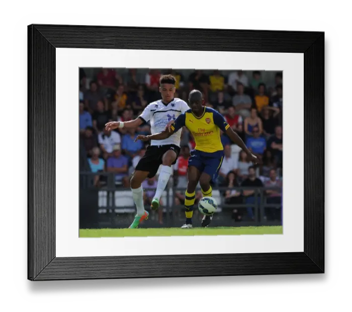 Framed Print : Abou Diaby vs. Lee Angol: A Fierce Rivalry Ignites in Arsenal's Pre-Season Clash with Boreham Wood