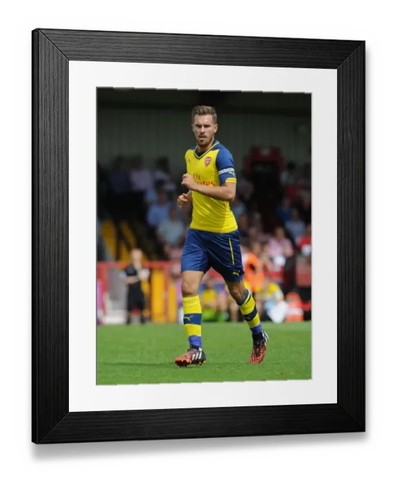 Framed Print : Arsenal's Aaron Ramsey in Action: Pre-Season Clash against Boreham Wood
