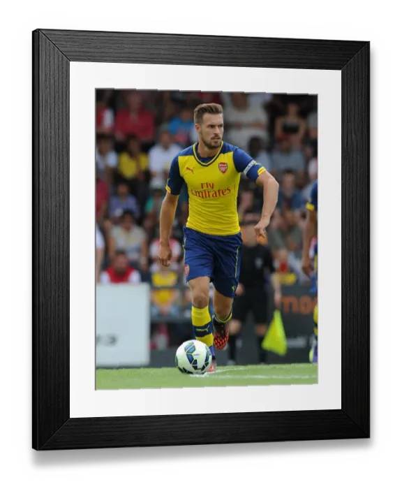Framed Print : Arsenal's Aaron Ramsey in Action: A Thrilling Pre-Season Clash against Boreham Wood Framed Print : Arsenal's Aaron Ramsey in Action: A Thrilling Pre-Season Clash against Boreham Wood