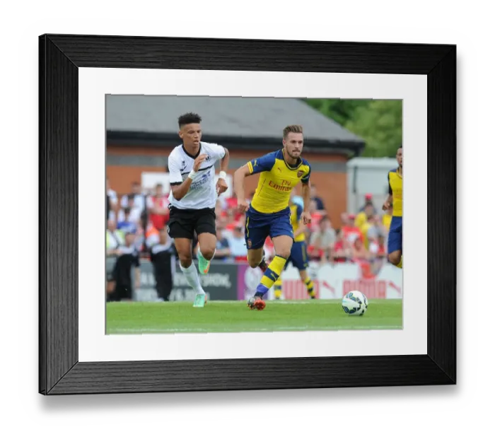 Framed Print : Aaron Ramsey vs Lee Angol: Battle in Arsenal's Pre-Season Clash against Boreham Wood