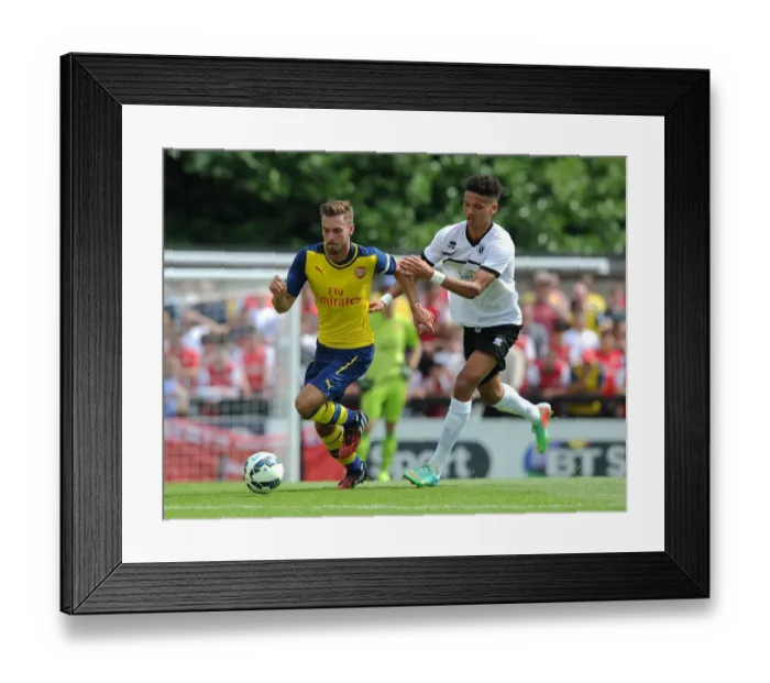 Framed Print : Aaron Ramsey Outmaneuvers Lee Angol: Borehamwood vs Arsenal Pre-Season Clash