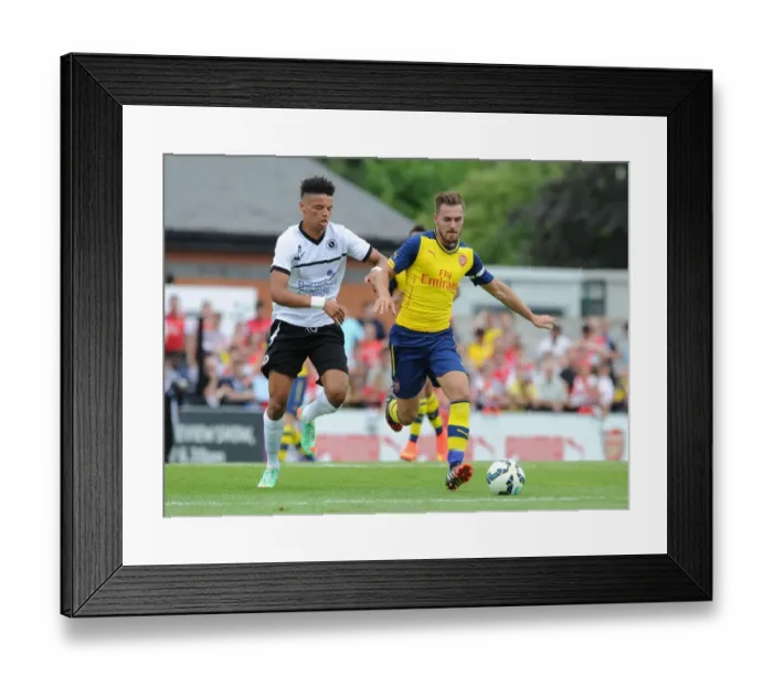 Framed Print : Clash of the Titans: Aaron Ramsey vs Lee Angol in Arsenal's Pre-Season Battle at Boreham Wood Framed Print : Clash of the Titans: Aaron Ramsey vs Lee Angol in Arsenal's Pre-Season Battle at Boreham Wood