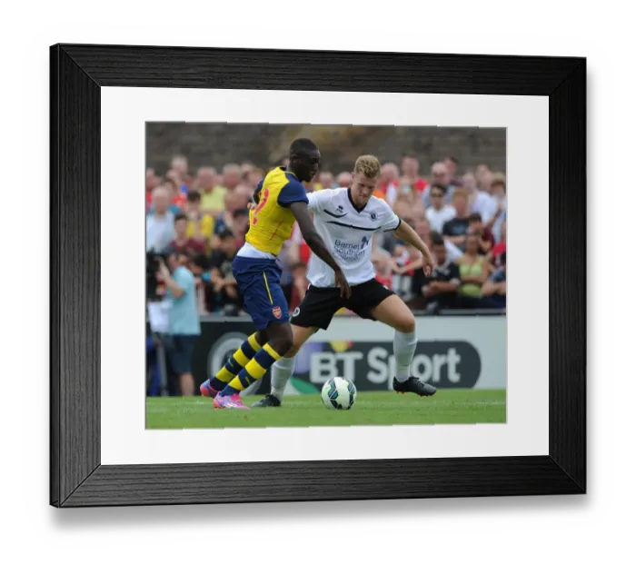 Framed Print : Yaya Sanogo vs Callum Reynolds: A Pre-Season Battle at Borehamwood Framed Print : Yaya Sanogo vs Callum Reynolds: A Pre-Season Battle at Borehamwood